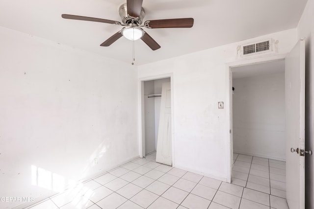 unfurnished bedroom with ceiling fan, a closet, and light tile patterned floors