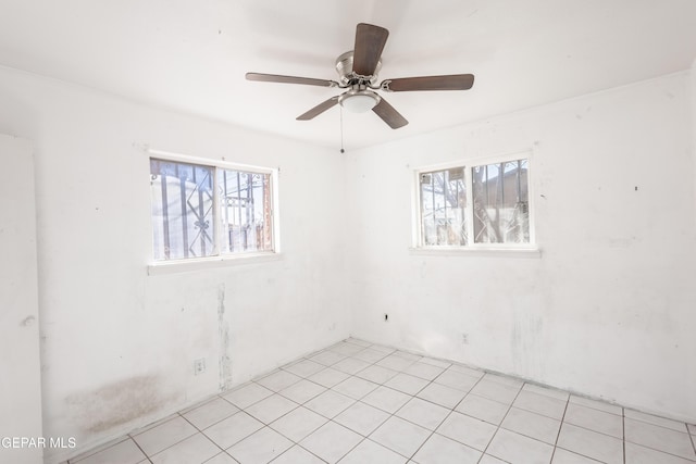 spare room featuring plenty of natural light and ceiling fan