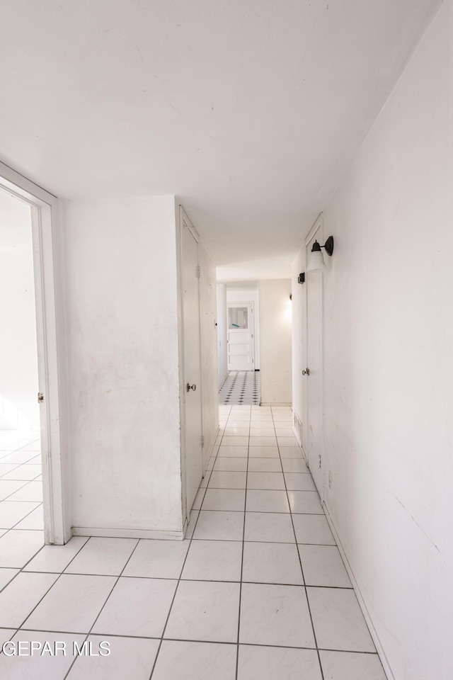 corridor featuring light tile patterned floors