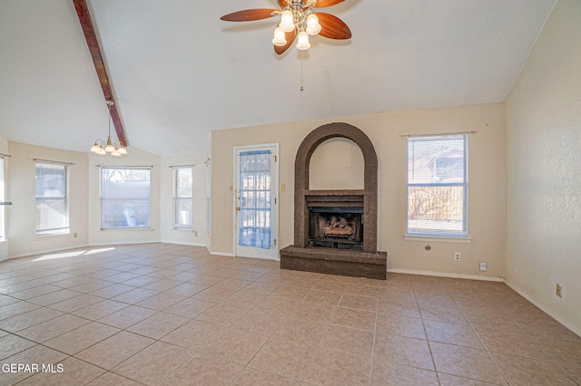 unfurnished living room featuring light tile patterned floors, ceiling fan with notable chandelier, lofted ceiling with beams, and a brick fireplace