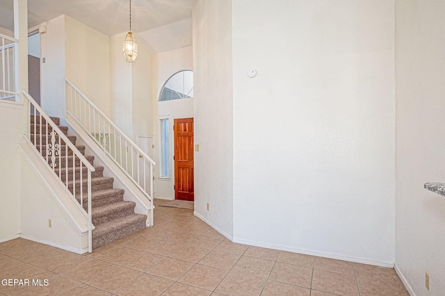 tiled foyer entrance with a high ceiling