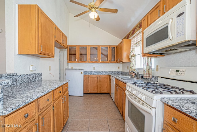 kitchen featuring sink, white appliances, light tile patterned floors, ceiling fan, and light stone counters