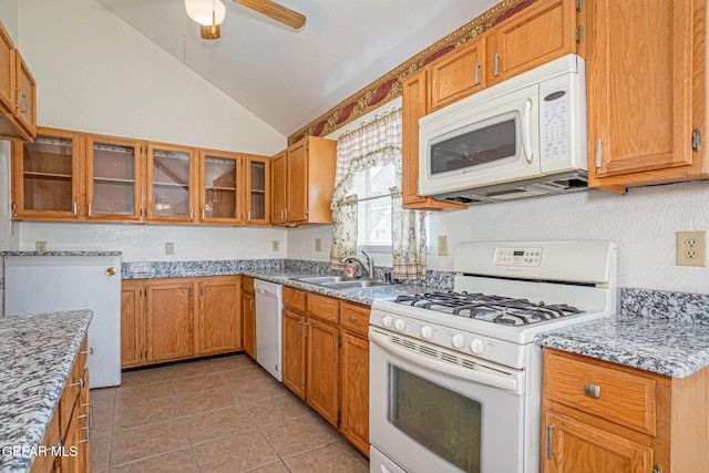 kitchen with lofted ceiling, sink, light tile patterned floors, ceiling fan, and white appliances