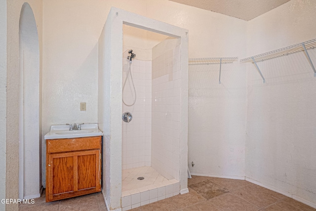 bathroom featuring vanity and a tile shower