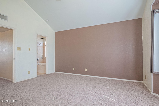 carpeted spare room with lofted ceiling