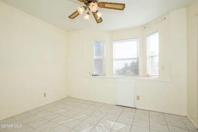 tiled empty room with ceiling fan