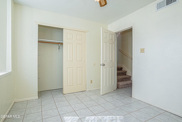 unfurnished bedroom featuring light tile patterned floors and a closet