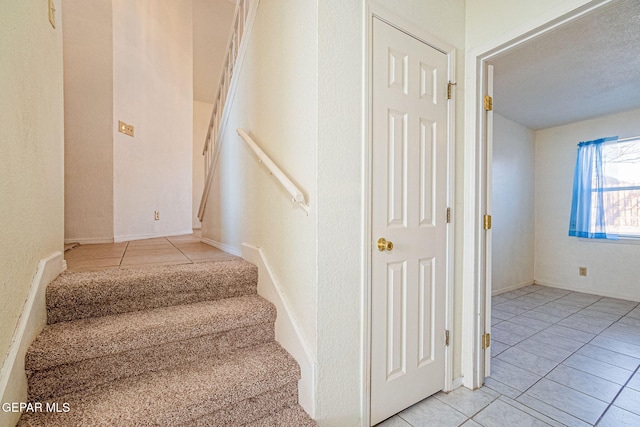 stairs with tile patterned floors