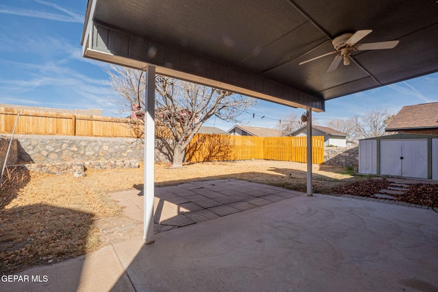 view of patio / terrace with ceiling fan and a storage shed