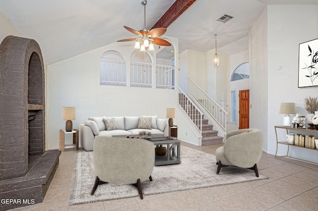 tiled living room with ceiling fan, a fireplace, high vaulted ceiling, and beam ceiling