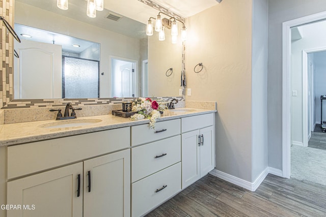 bathroom featuring vanity, hardwood / wood-style floors, backsplash, and walk in shower