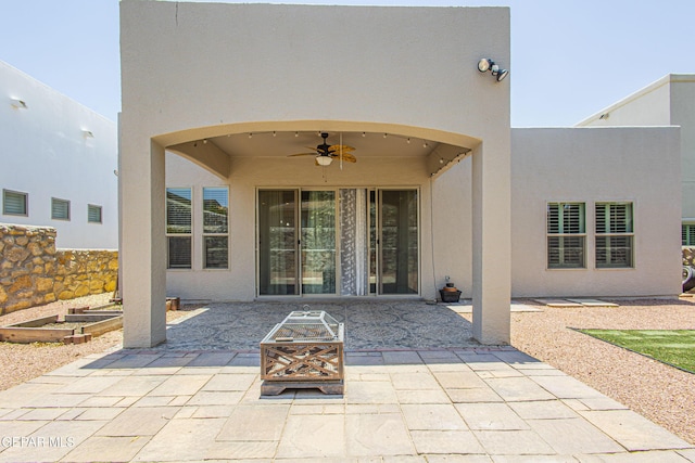 view of patio / terrace with ceiling fan and an outdoor fire pit