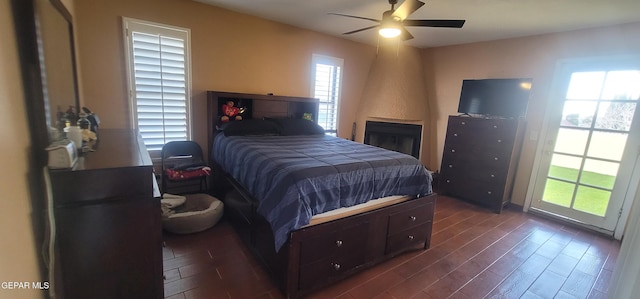 bedroom featuring dark hardwood / wood-style flooring, access to outside, and ceiling fan