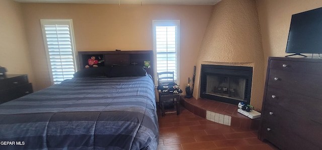 bedroom featuring a large fireplace