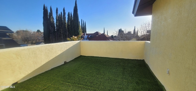 view of yard with a balcony