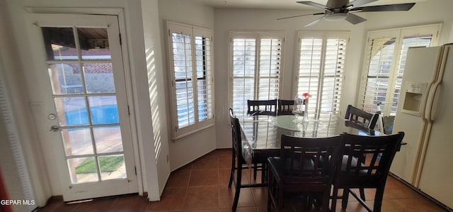 tiled dining room featuring ceiling fan