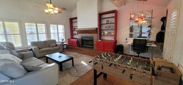 living room featuring tile patterned flooring, a tile fireplace, lofted ceiling, and ceiling fan