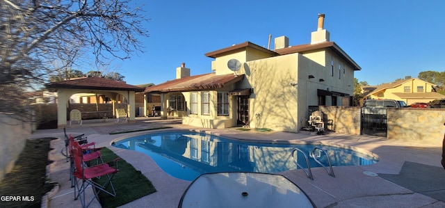 view of swimming pool featuring a gazebo and a patio