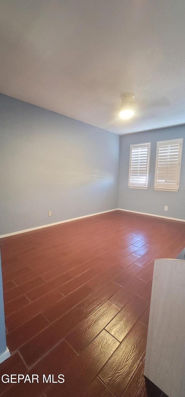 unfurnished room featuring dark hardwood / wood-style flooring