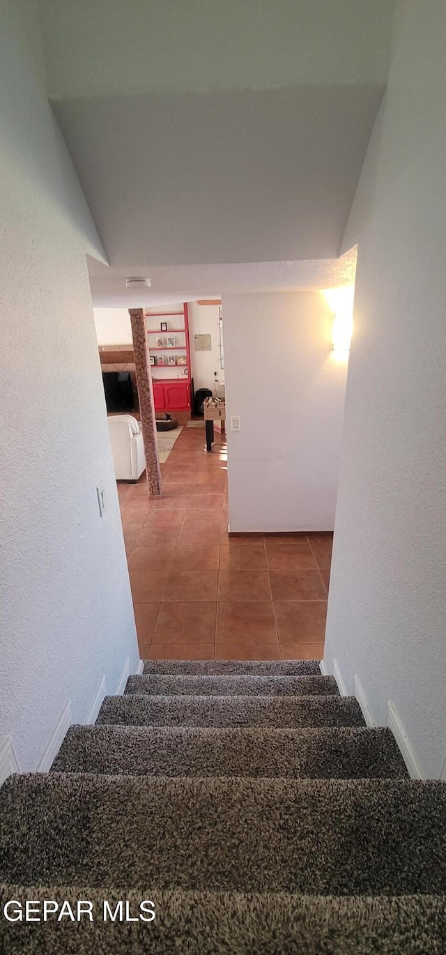 staircase featuring tile patterned floors