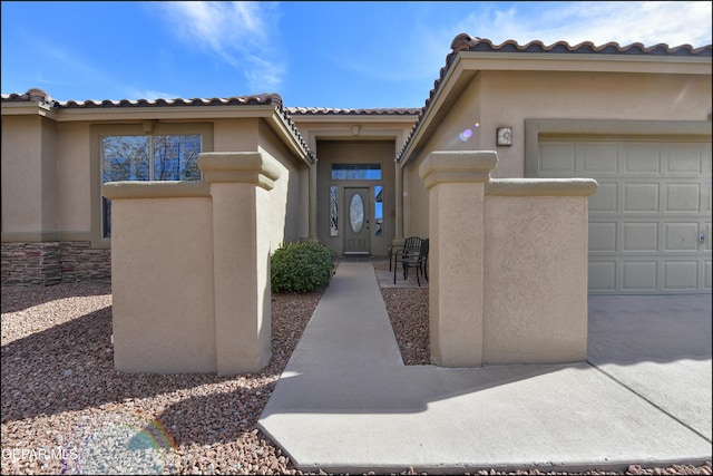 view of exterior entry featuring a garage