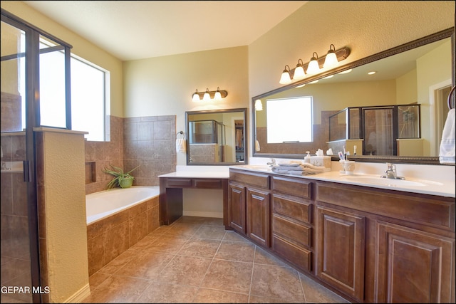 bathroom featuring tile patterned floors, vanity, and separate shower and tub