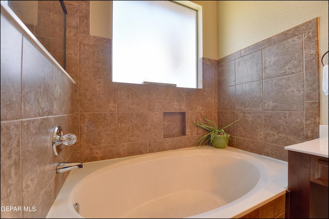 bathroom with vanity and a tub to relax in