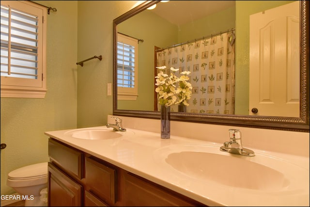 bathroom with vanity, a shower with curtain, and toilet