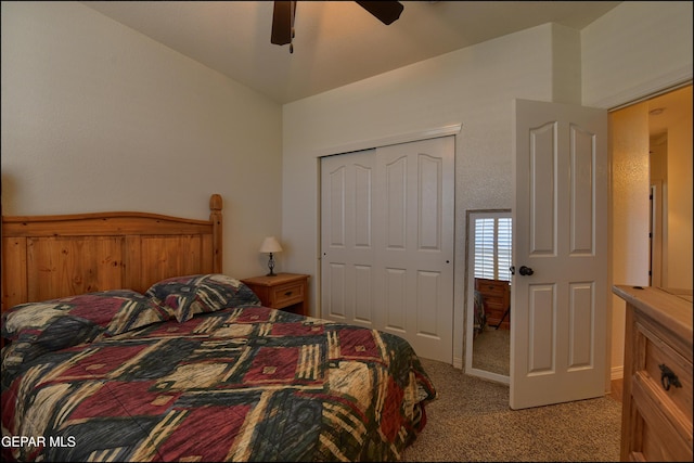 carpeted bedroom with ceiling fan, lofted ceiling, and a closet