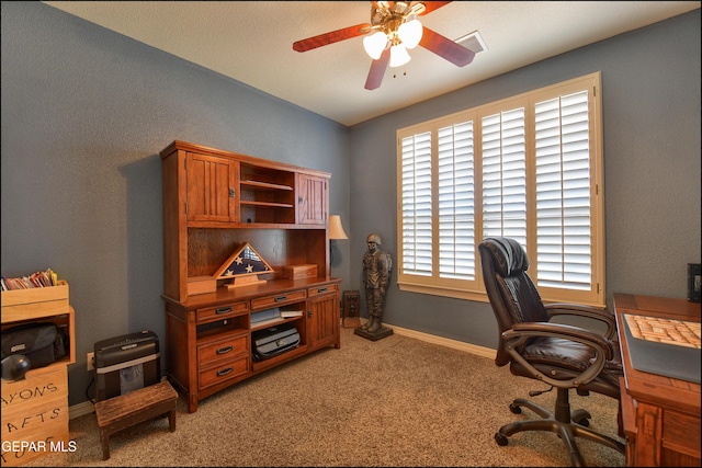 office area featuring light carpet and ceiling fan