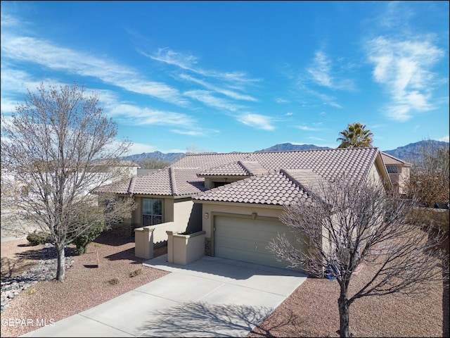 view of front of home featuring a garage and a mountain view