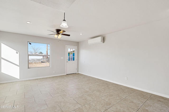 interior space with a textured ceiling, an AC wall unit, and ceiling fan