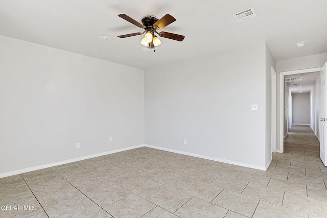 tiled empty room featuring ceiling fan