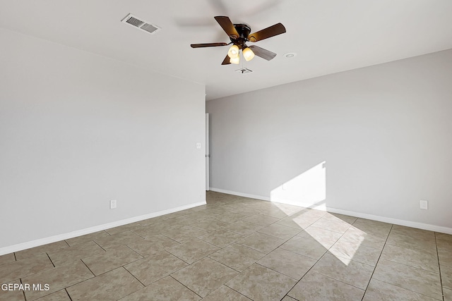 spare room with light tile patterned floors and ceiling fan