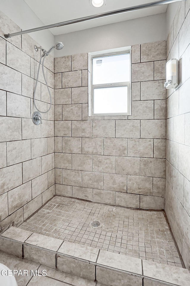 bathroom with tiled shower