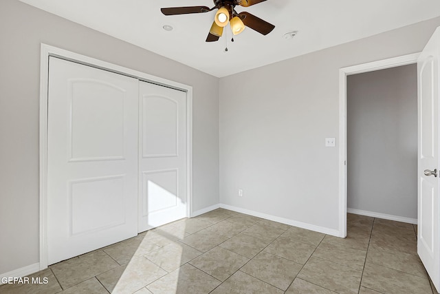 unfurnished bedroom featuring light tile patterned flooring, ceiling fan, and a closet