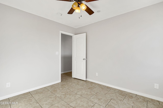 tiled spare room with ceiling fan