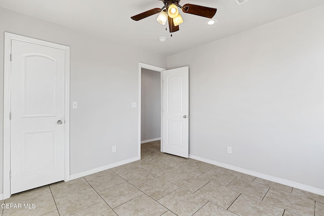 unfurnished bedroom featuring light tile patterned floors and ceiling fan