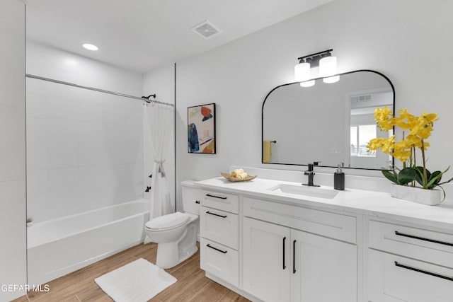 full bathroom with vanity, toilet, hardwood / wood-style floors, and shower / bath combo with shower curtain