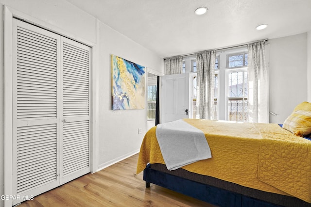 bedroom with wood-type flooring and a closet