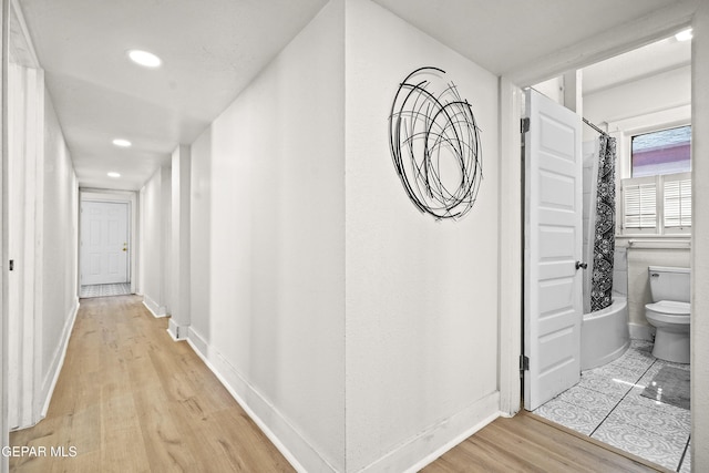 hallway with light wood-type flooring