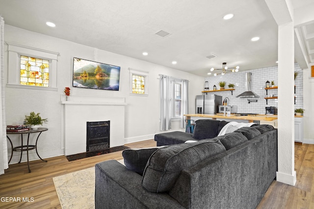 living room with light hardwood / wood-style floors and a healthy amount of sunlight