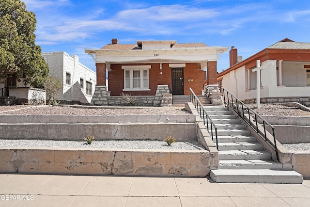 view of front of house featuring a porch and brick siding