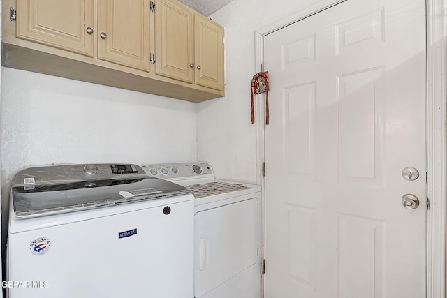 laundry room featuring cabinets and washing machine and clothes dryer