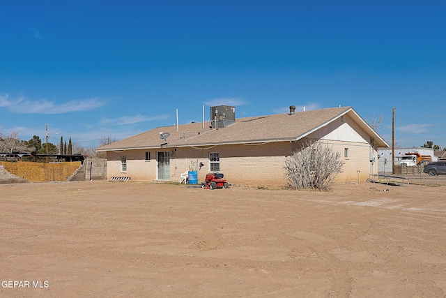 rear view of house featuring central air condition unit