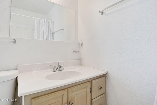 bathroom with vanity and toilet