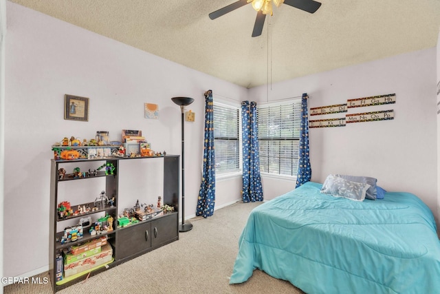 bedroom with lofted ceiling, ceiling fan, a textured ceiling, and carpet