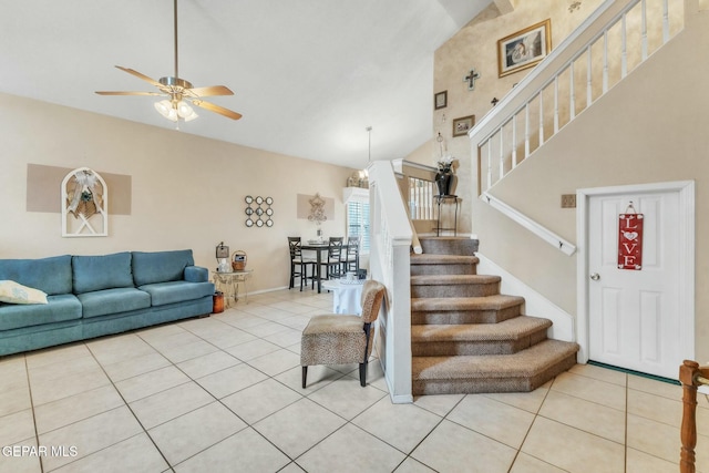 tiled living room featuring lofted ceiling and ceiling fan