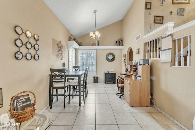 tiled dining room with high vaulted ceiling and an inviting chandelier