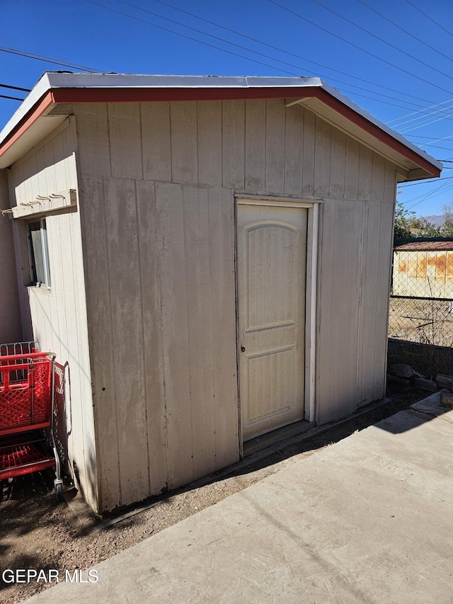 view of shed with fence